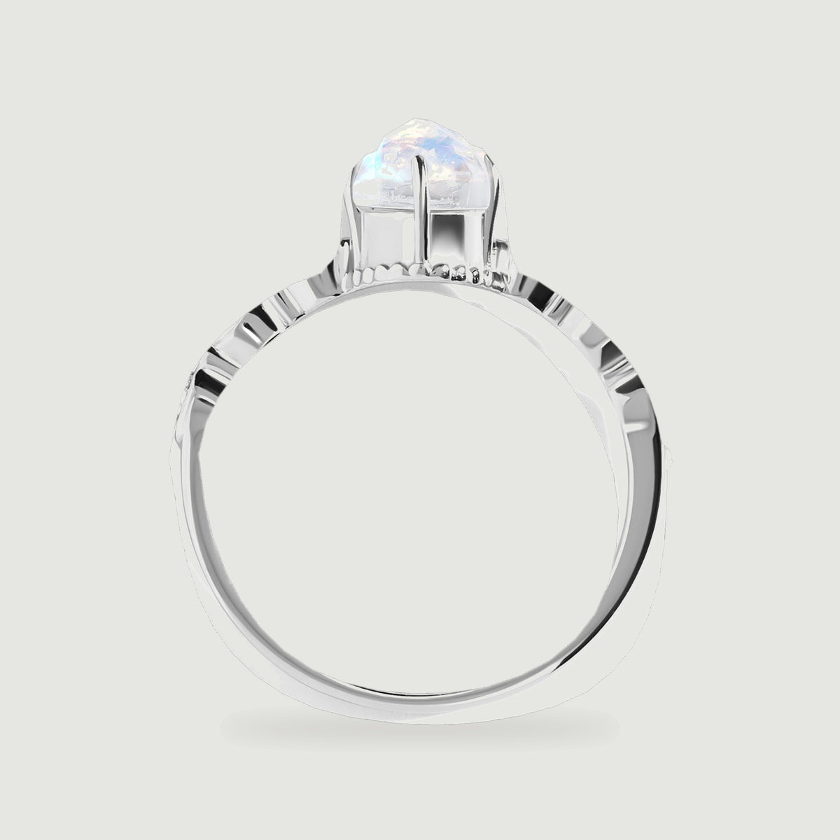 The white gold ring is shown from the side, revealing the raised moonstone setting and the open band.