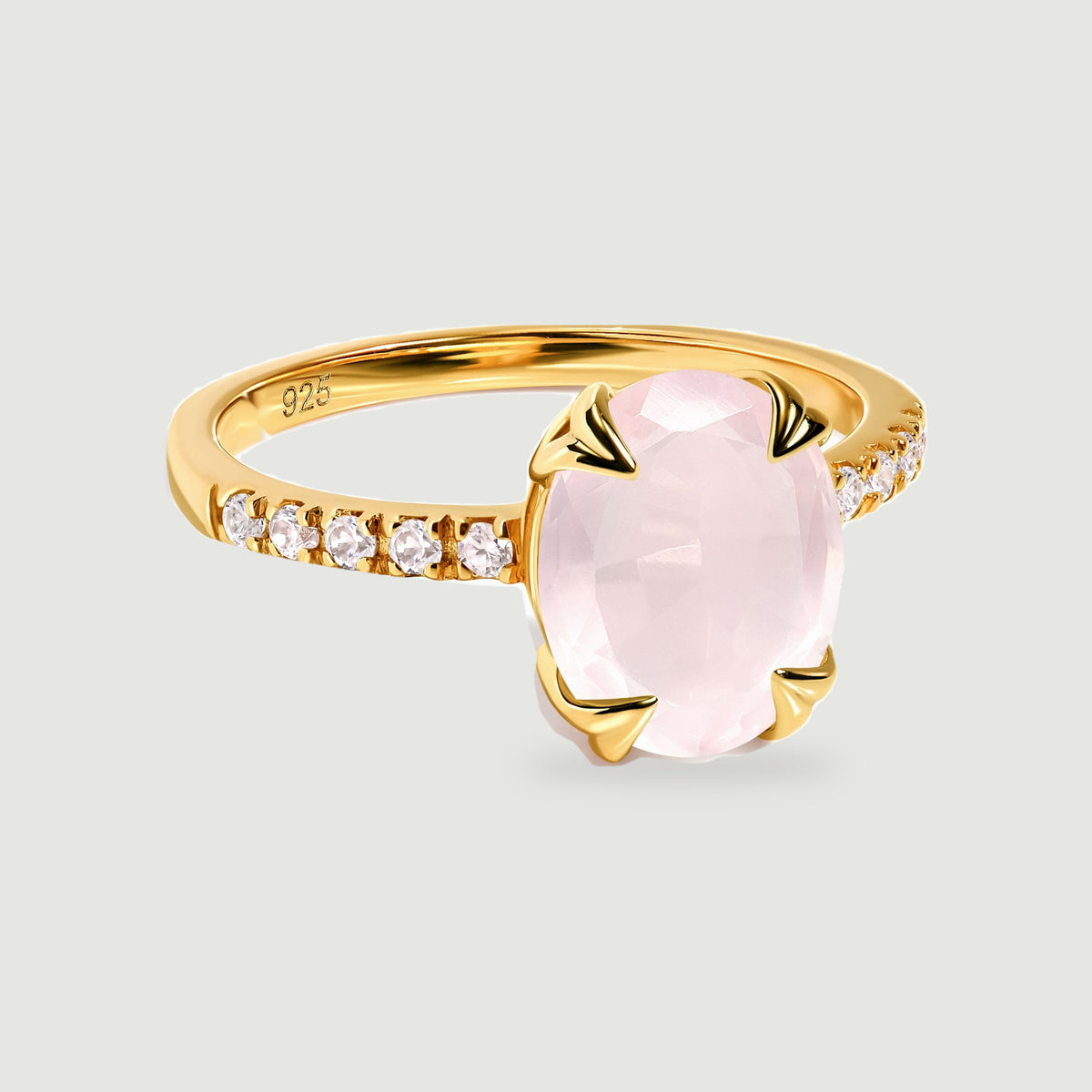 A yellow gold vermeil ring presents a faceted blush pink oval stone between four polished prongs.