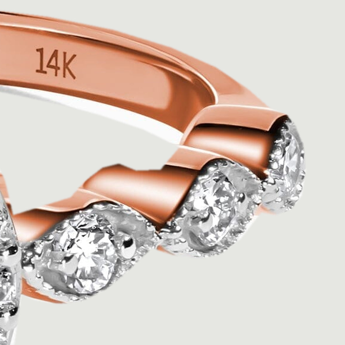 The right shoulder reveals diamond settings beside the polished rose gold band and its 14K stamp.