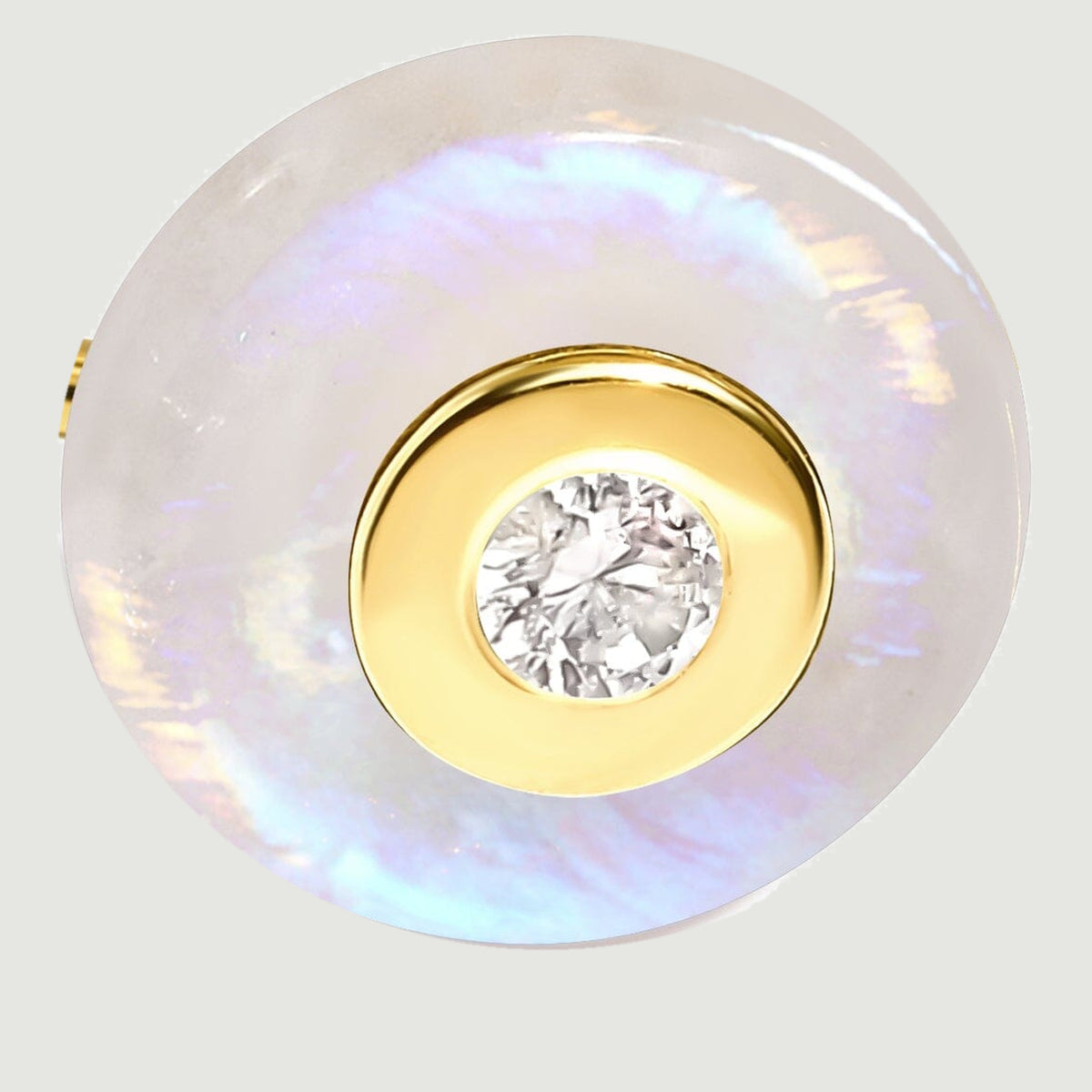 A close-up shows the yellow gold vermeil bezel surrounding a clear center stone within a round moonstone disc.