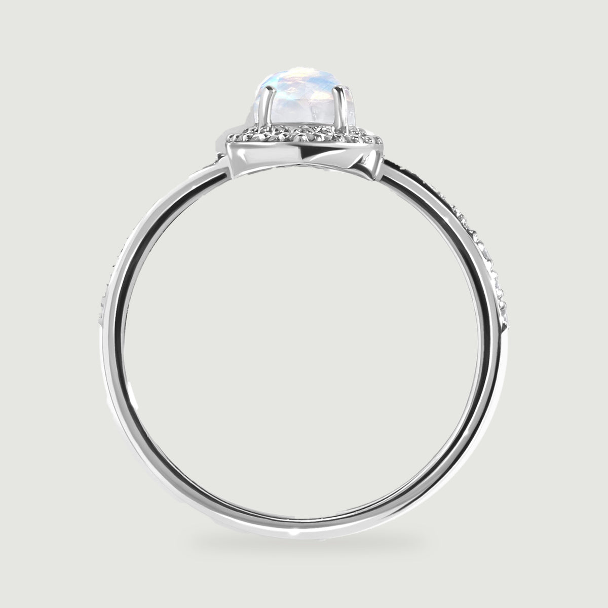 The white gold ring is shown from the side with raised prongs and a polished circular band.