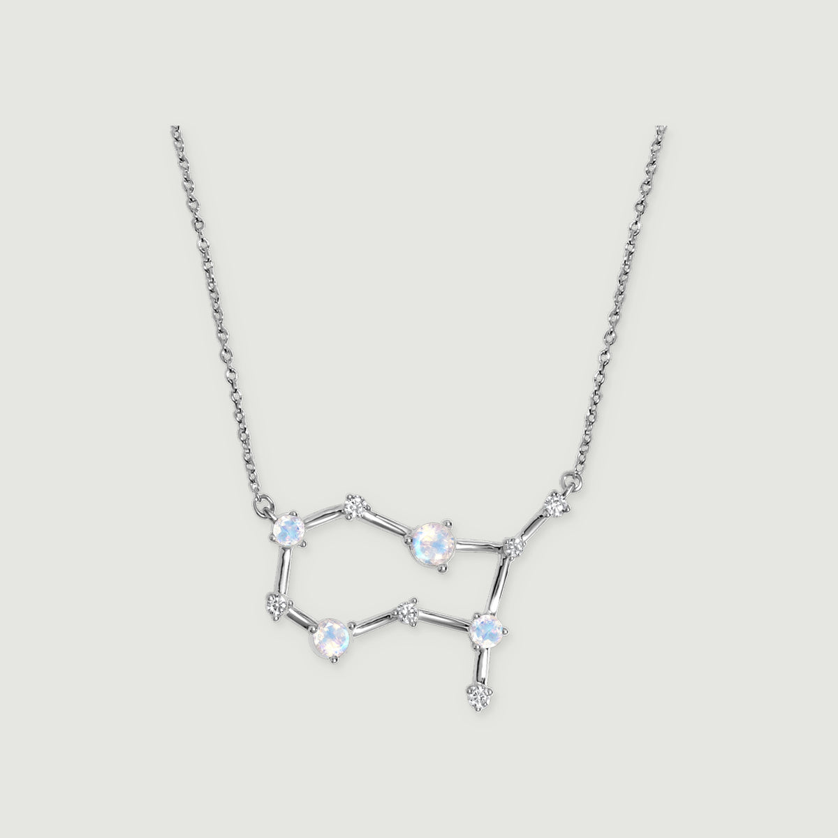 A silver necklace shows blue flashes in its round moonstones, linked by slender polished bars.