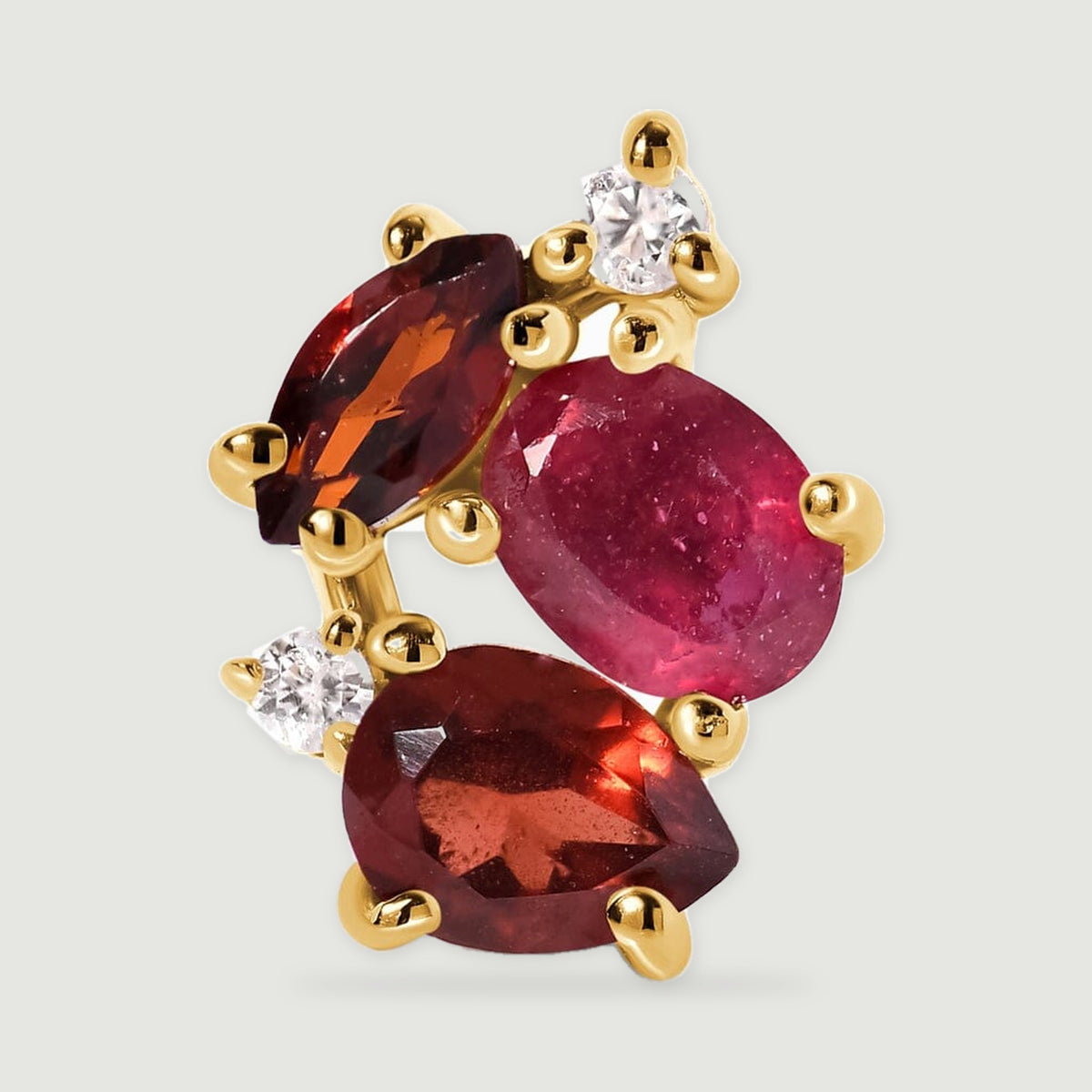 A close view of one yellow gold vermeil earring shows an oval pink center stone framed by marquise and pear shaped red stones.