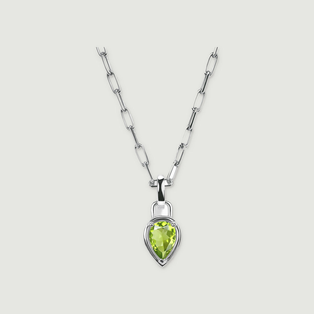 A pear-shaped green peridot pendant hangs from a silver-tone elongated-link chain against a light gray background.