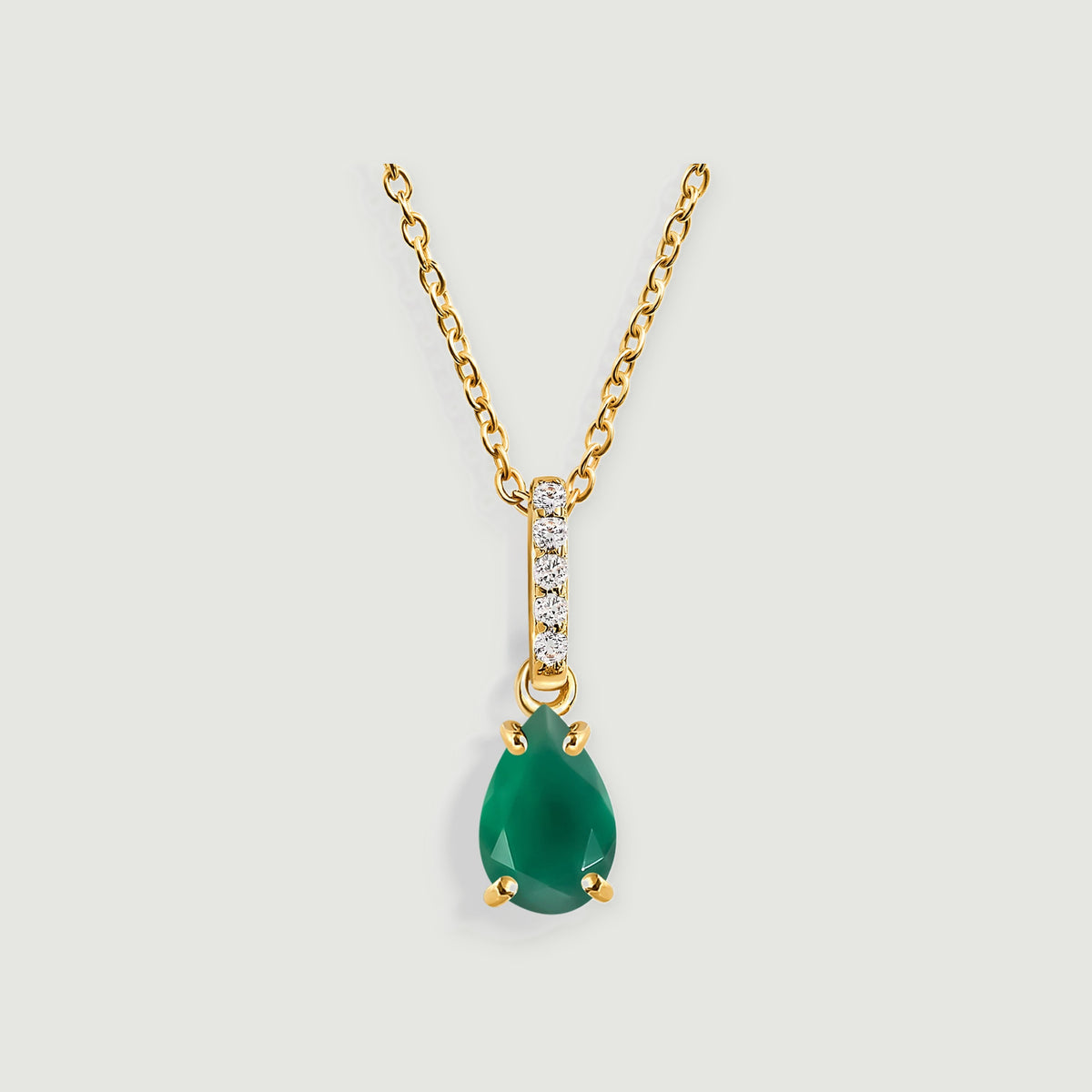 A green pear-shaped pendant hangs below a yellow gold bail set with five clear stones.