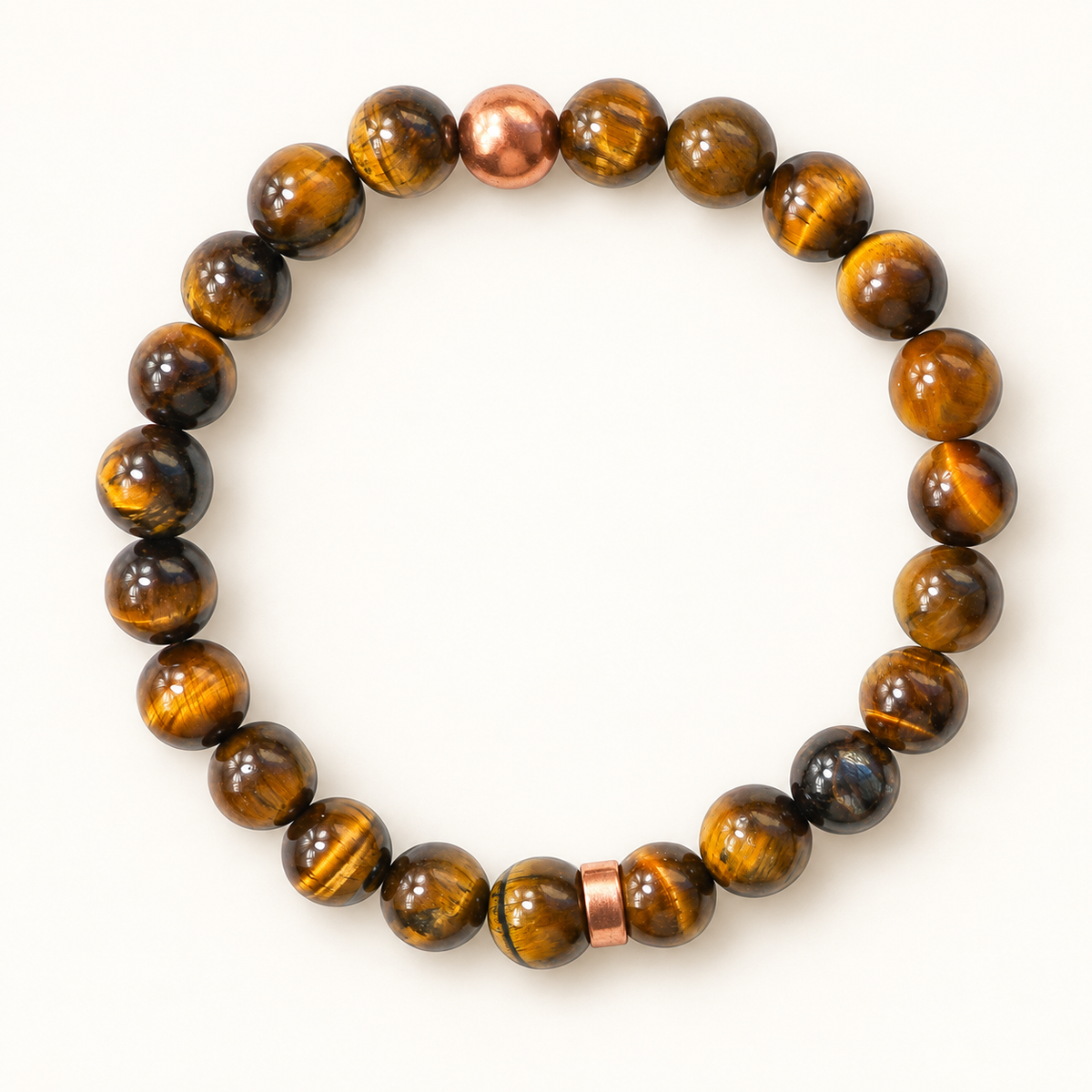 Golden Resolve tiger's eye and copper bead bracelet, complete bracelet with plain copper spacer on an off-white background.