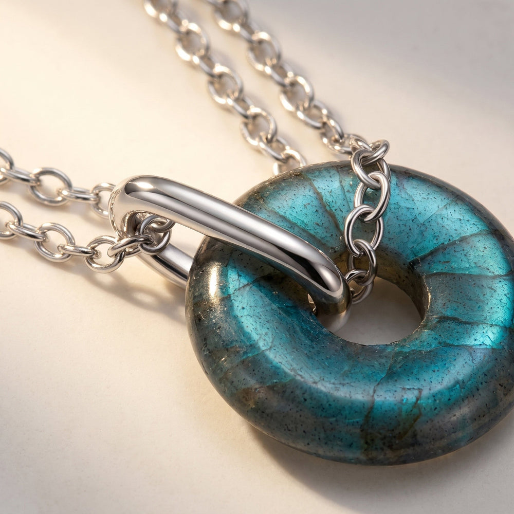 Labradorite donut pendant on a silver link chain, close-up