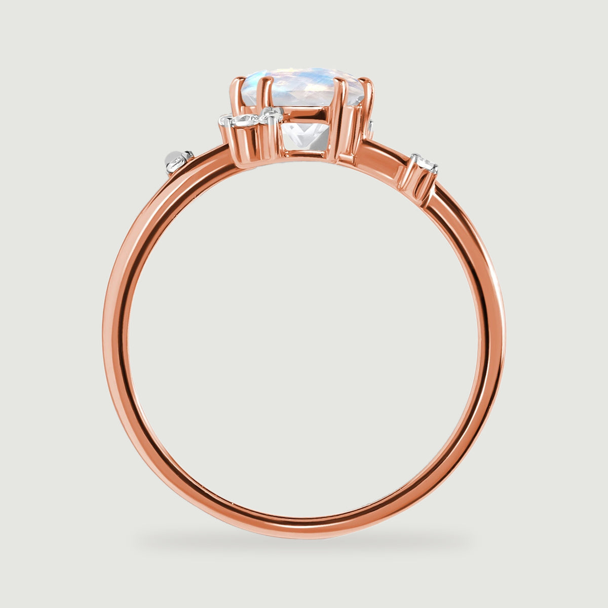 The rose gold ring is shown from the side with its open stone setting and slender circular band.