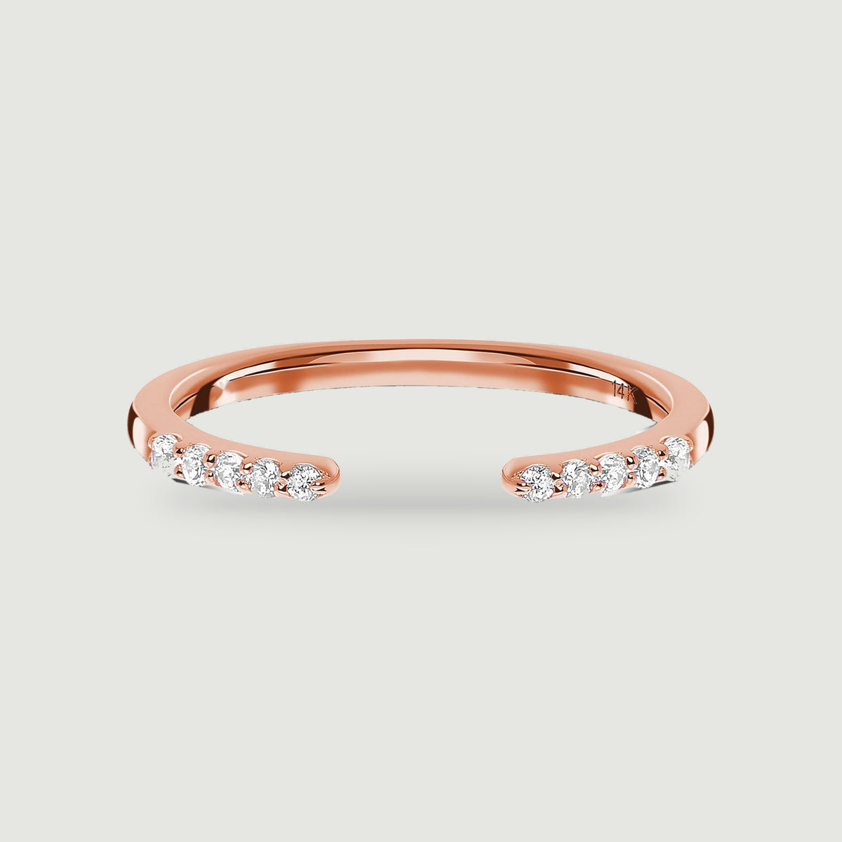 A rose gold open ring has five round diamonds on each end of its polished band.