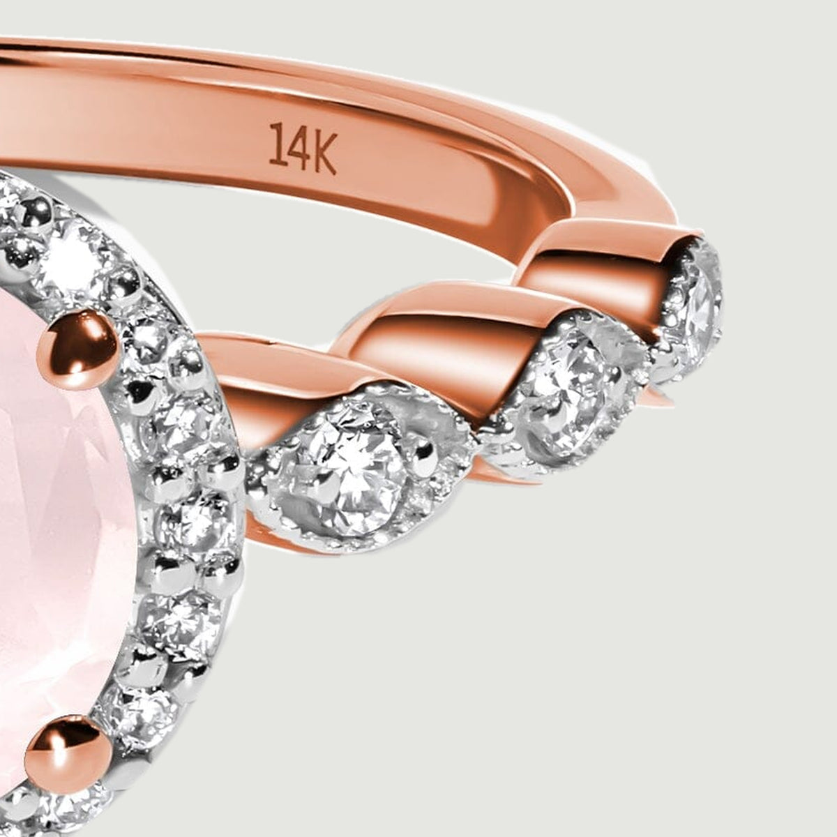 The right diamond-set shoulder meets a polished rose gold band beside the round stone setting.