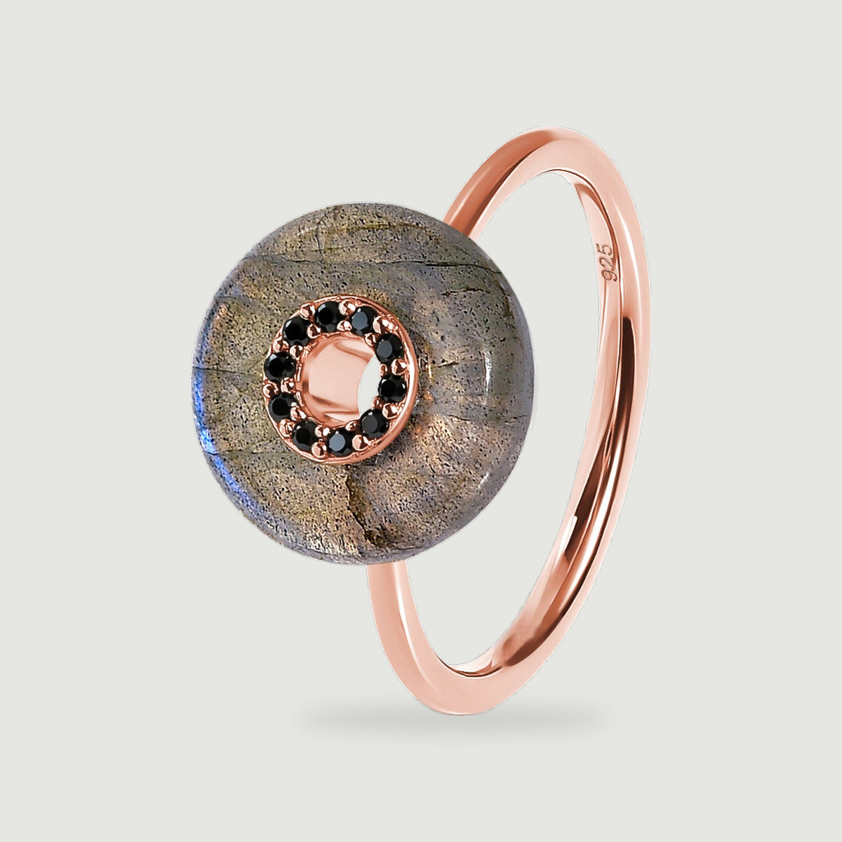 A rose gold vermeil band supports a circular labradorite disc with dark stones around the open centre.