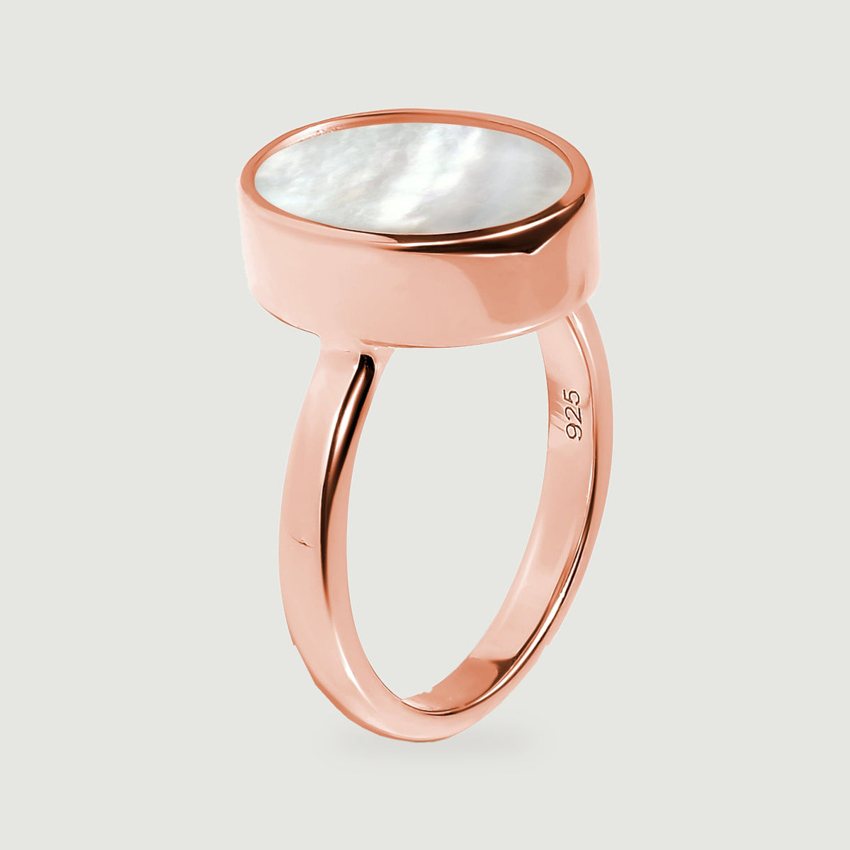 The side view reveals the raised oval setting and curved rose gold ring band.