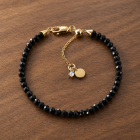 Night Shield black obsidian bracelet in 18kt yellow gold vermeil on warm walnut