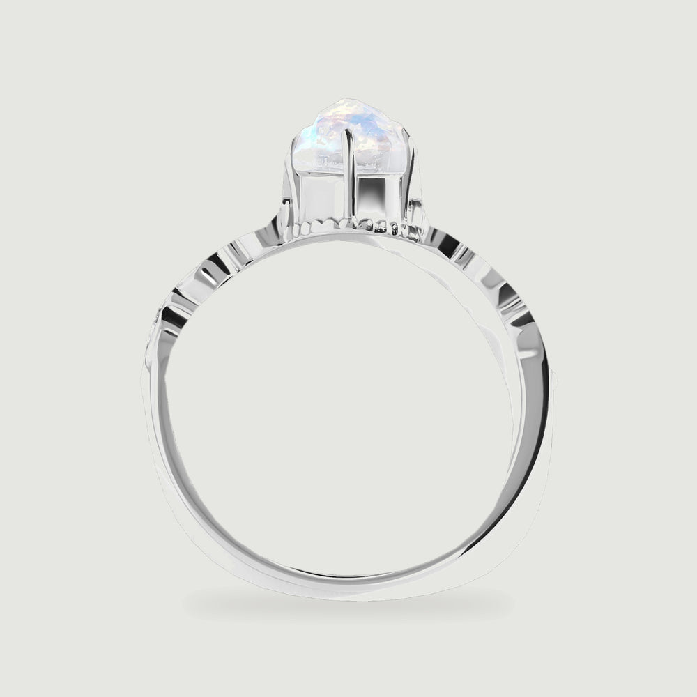 The white gold ring is shown from the side, revealing the raised moonstone setting and the open band.