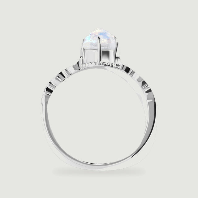 The white gold ring is shown from the side, revealing the raised moonstone setting and the open band.