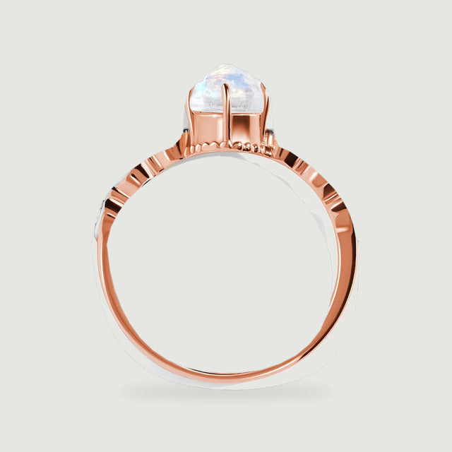A side view of the rose gold ring shows its elevated prong setting above the curved polished band.