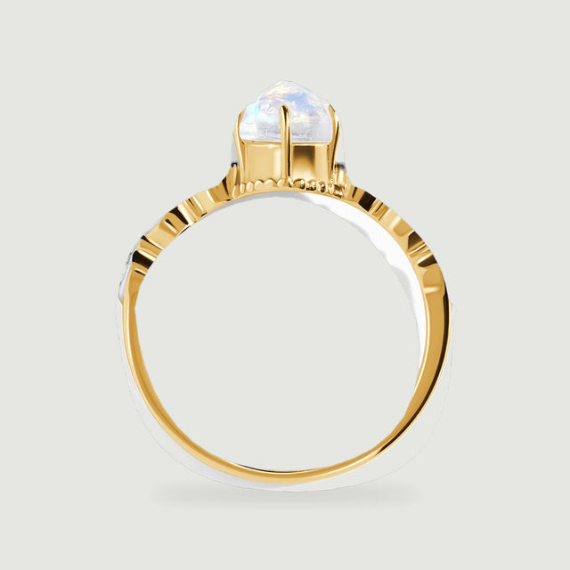The yellow gold ring is viewed in profile with the moonstone basket rising above the diamond shoulders.