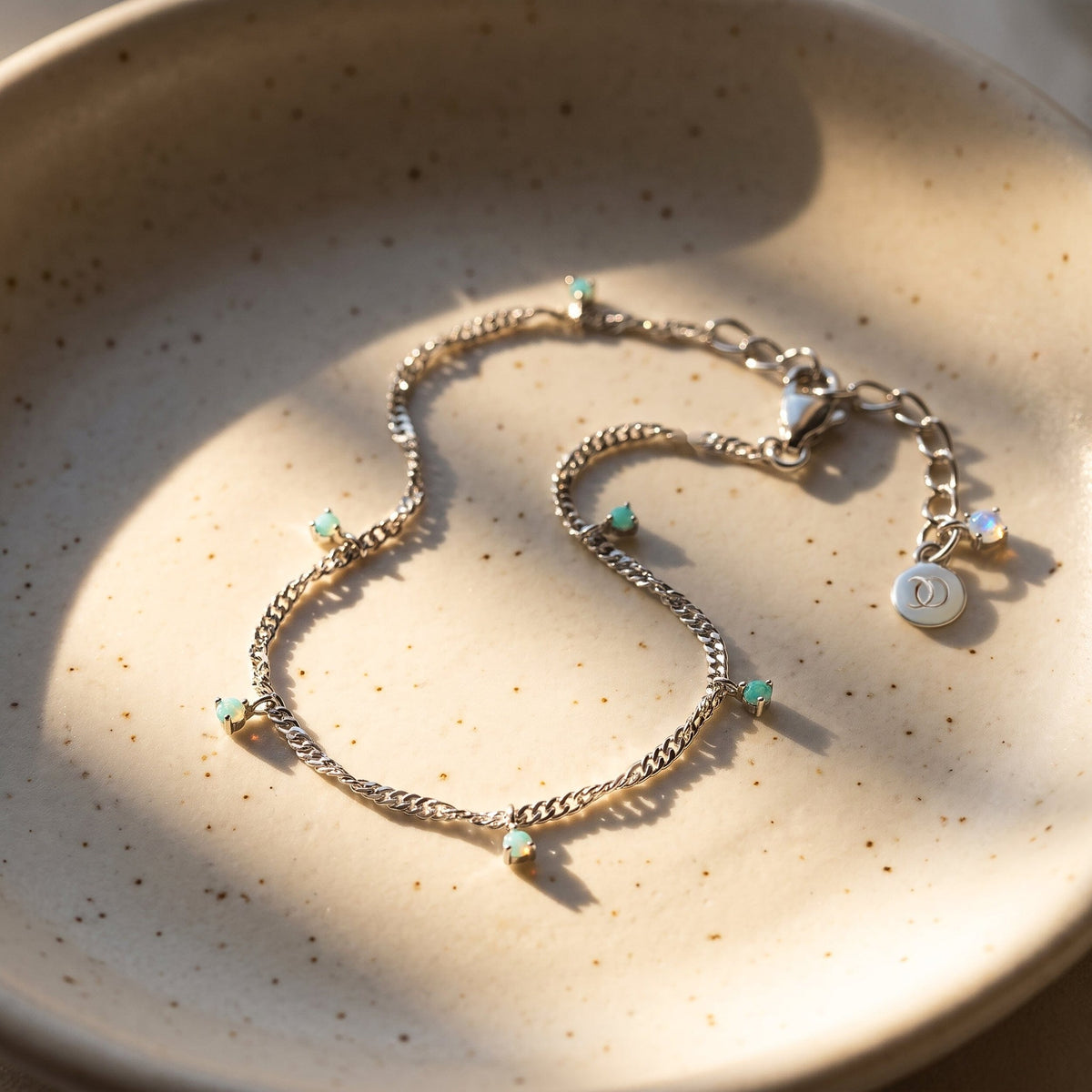 Blue-green anklet profile resting flat