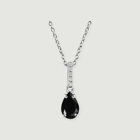 A sterling silver chain holds a pear-shaped black onyx pendant below a narrow diamond-set bail on a light gray background.