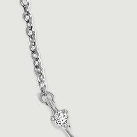 Oval silver chain links lead to a circular connector and a clear stone at the pendant tip.