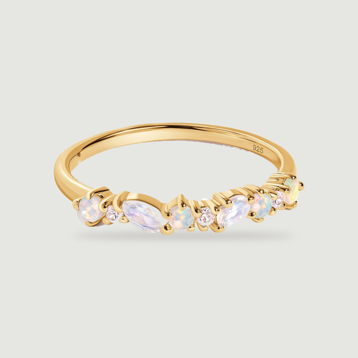 A yellow gold ring shows round opals, two marquise moonstones and tiny clear stones across its curved front.
