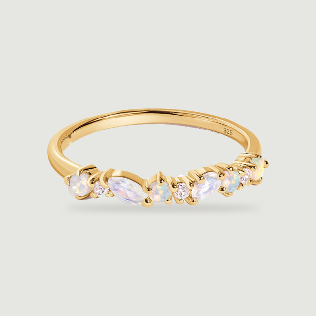 A yellow gold ring shows round opals, two marquise moonstones and tiny clear stones across its curved front.