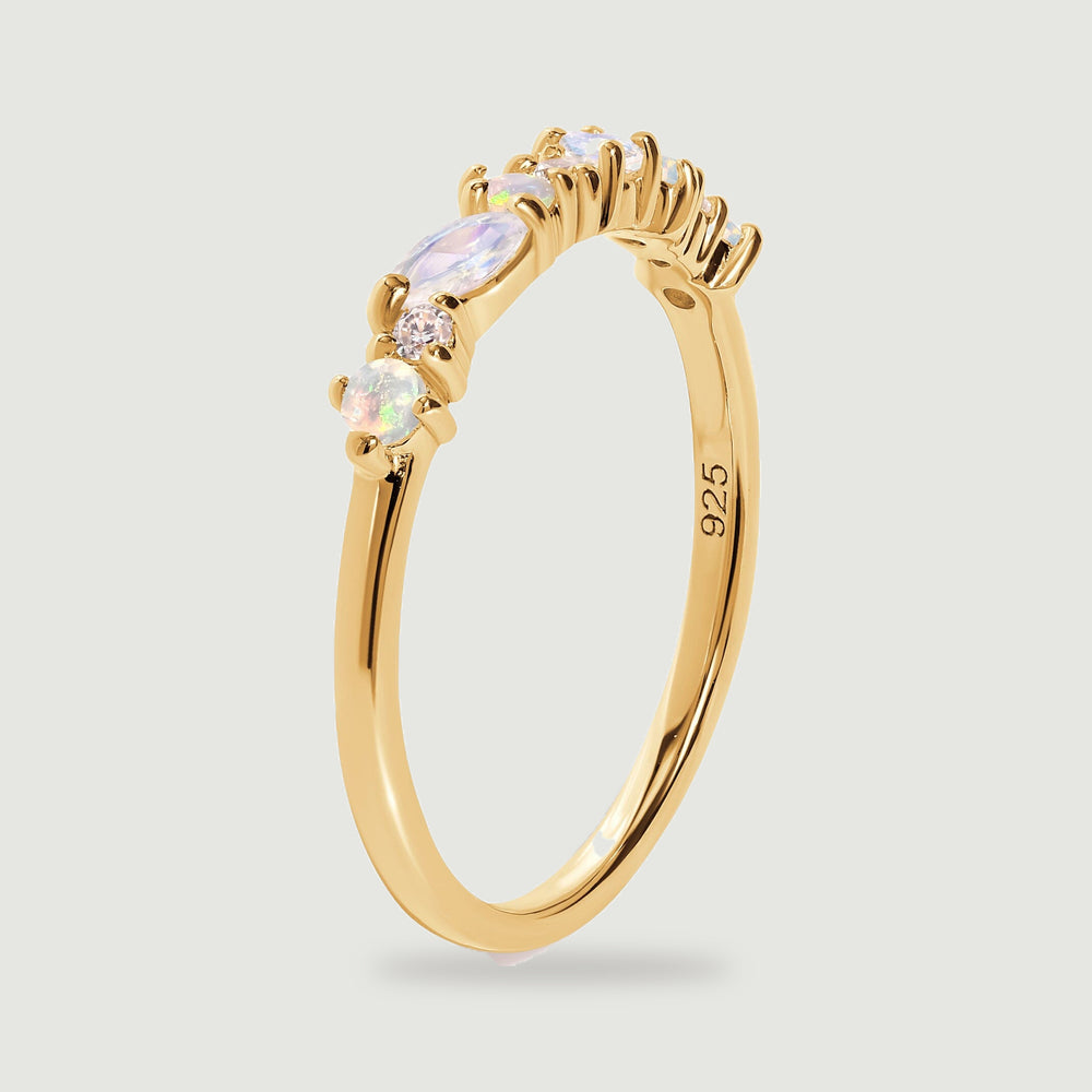 The yellow gold ring stands at an angle, showing its raised prongs and smooth inner band.