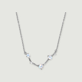 A silver necklace with an angular stone-set centre and a fine link chain is centred on a light grey background.