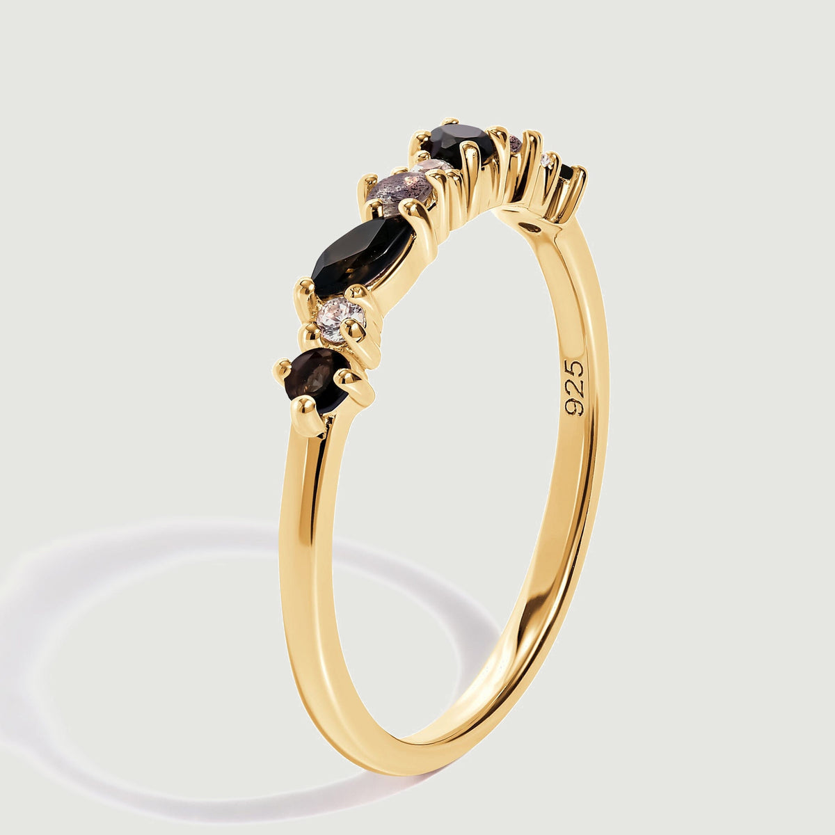The upright yellow gold ring shows raised stone settings, a slender band and a visible 925 stamp.