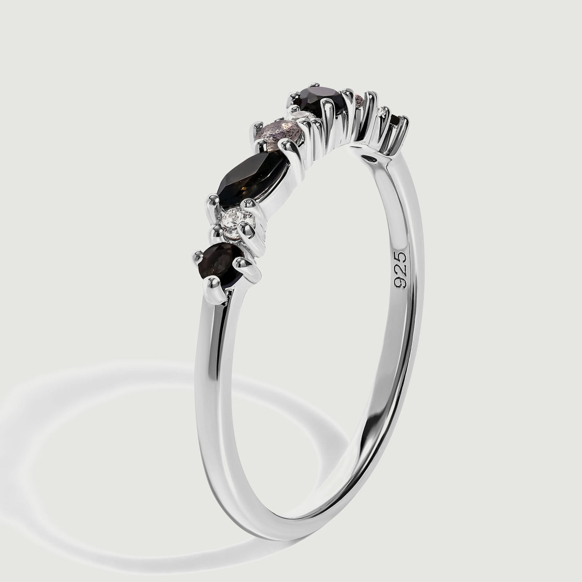 A side angle reveals the silver band, elevated gemstone prongs and the 925 purity stamp.