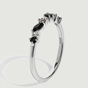 A side angle reveals the silver band, elevated gemstone prongs and the 925 purity stamp.
