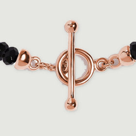 The rose gold vermeil toggle and connecting chain sit between two sections of faceted black obsidian beads.