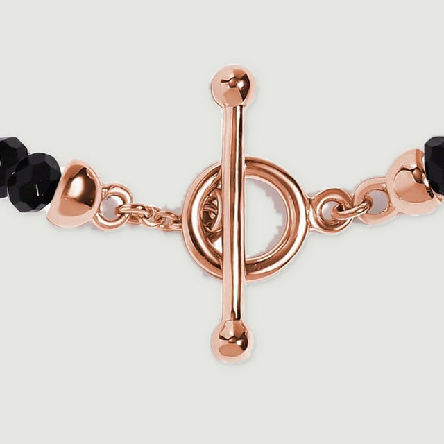 The rose gold vermeil toggle and connecting chain sit between two sections of faceted black obsidian beads.