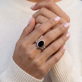Hand wearing the black onyx ring with a black spinel band