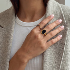 Hand wearing the black onyx ring with a white top