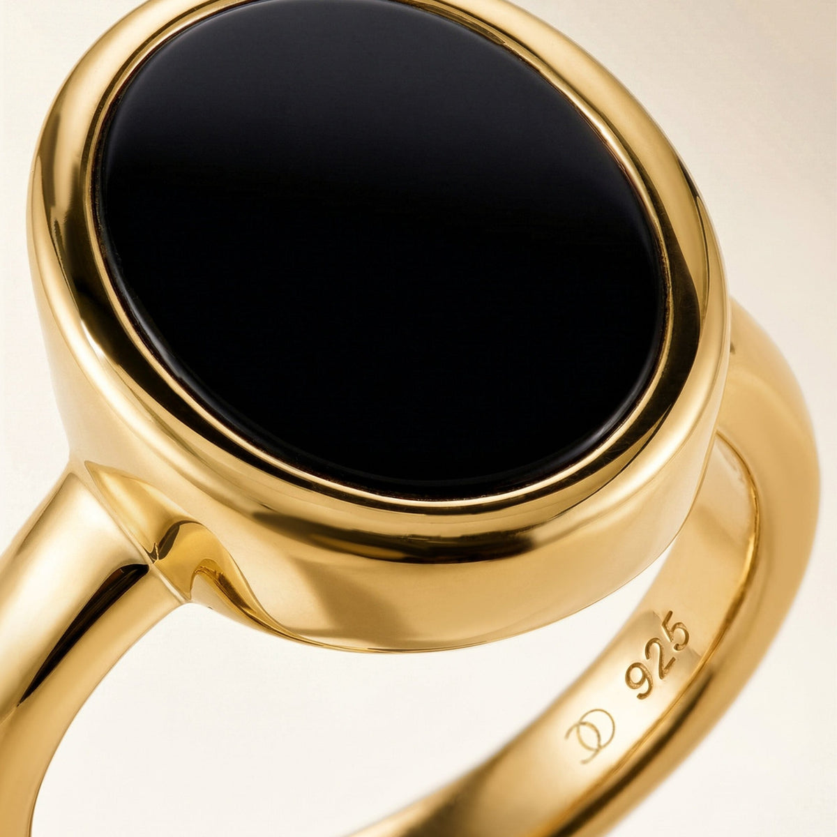 Gold ring with an oval black onyx stone, close-up