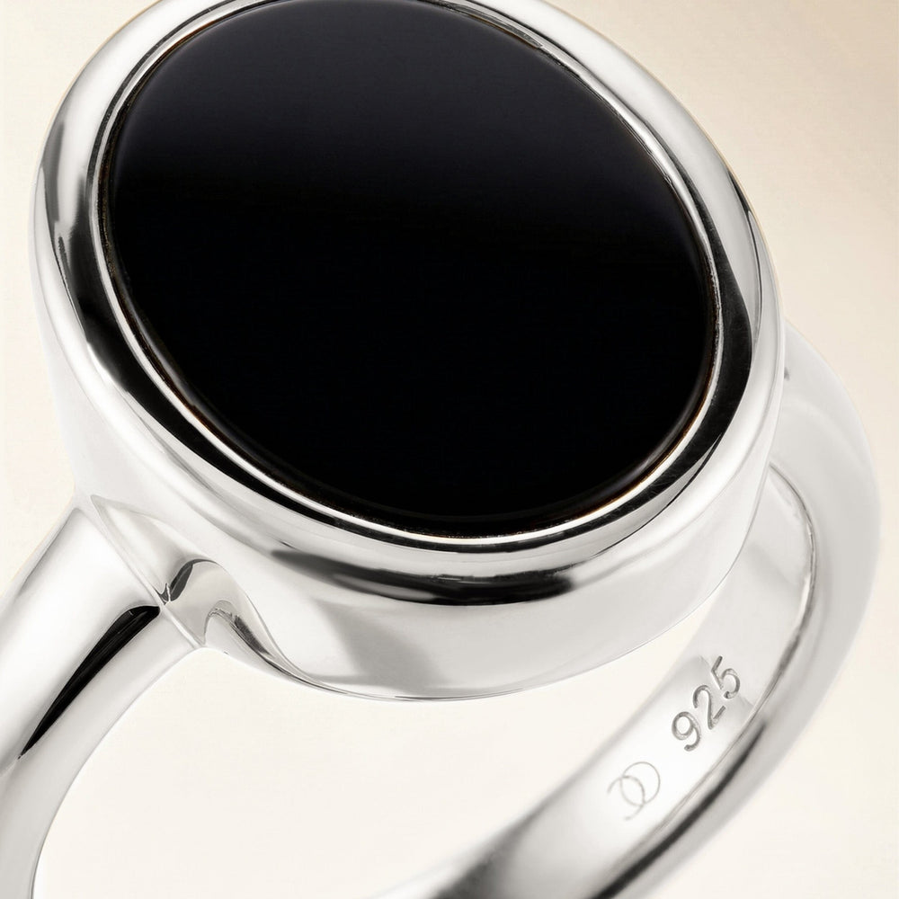 Silver ring with an oval black onyx stone, close-up