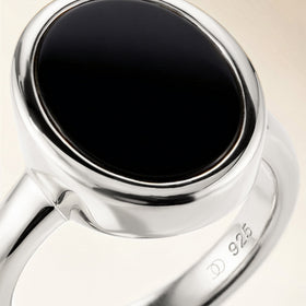 Silver ring with an oval black onyx stone, close-up