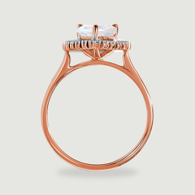 The side of the rose gold ring shows a raised moonstone setting, diamond halo and slender circular band.