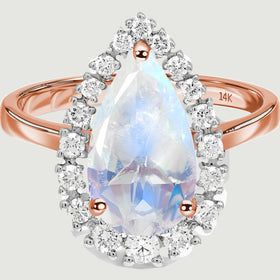 A close view shows the pear-shaped moonstone, round diamond halo and three rose gold prongs.