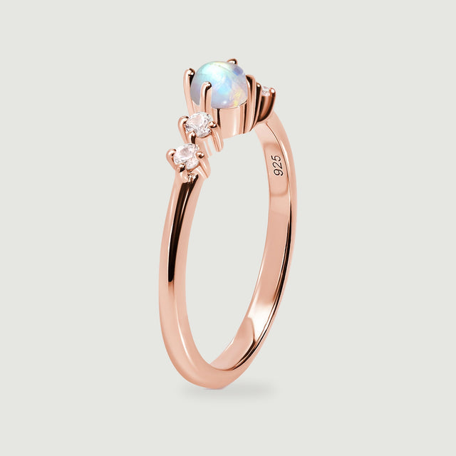 The side of the rose gold ring shows the raised moonstone setting and polished band.