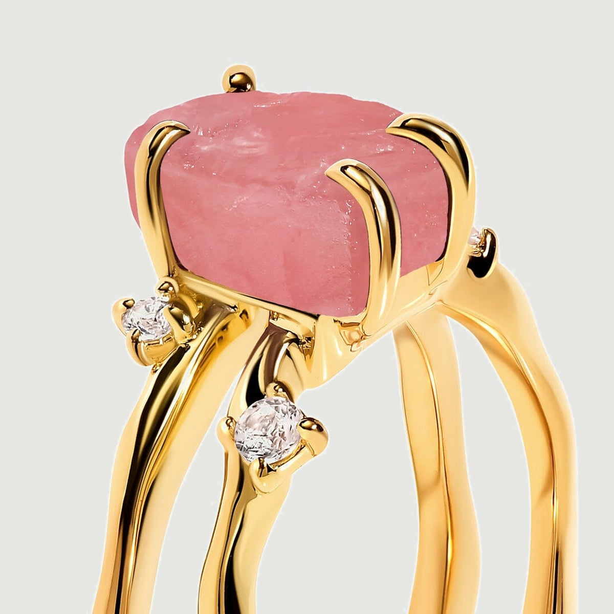 A side close-up shows the rough pink stone above two yellow gold bands with clear accent stones.