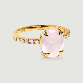 A yellow gold vermeil ring presents a faceted blush pink oval stone between four polished prongs.