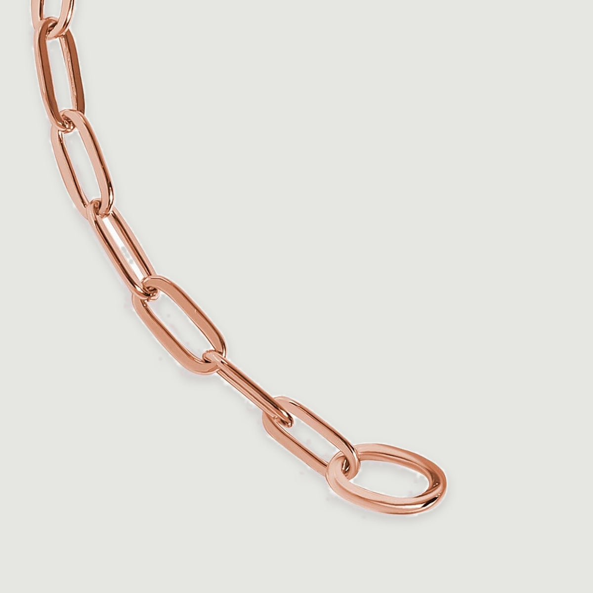 An oval end loop joins the final elongated links of the rose gold bracelet.