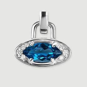 The silver-tone pendant is shown from the front with a broad polished bail and a faceted blue center stone.