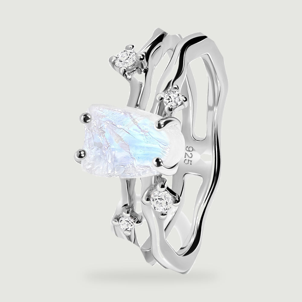 An angled silver ring shows the raised moonstone setting and two wavy bands.