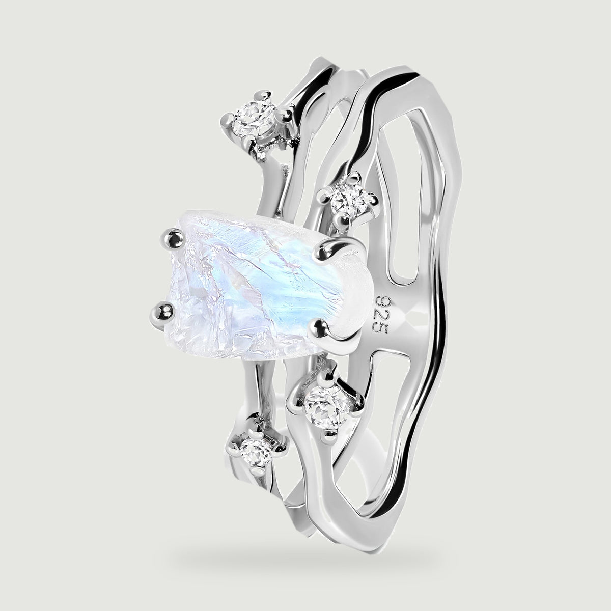 An angled silver ring shows the raised moonstone setting and two wavy bands.