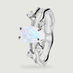 An angled silver ring shows the raised moonstone setting and two wavy bands.