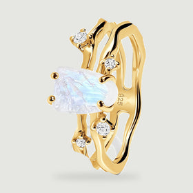 The yellow gold ring stands at an angle with its open band and four prongs visible.