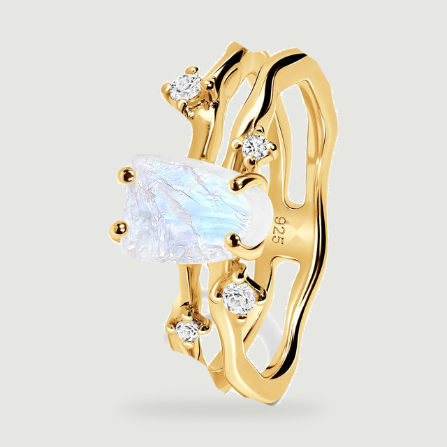 The yellow gold ring stands at an angle with its open band and four prongs visible.